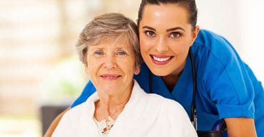 A woman and an older lady smiling for the camera.